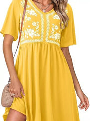 Yellow V-neck mini dress with white floral embroidery and short sleeves.