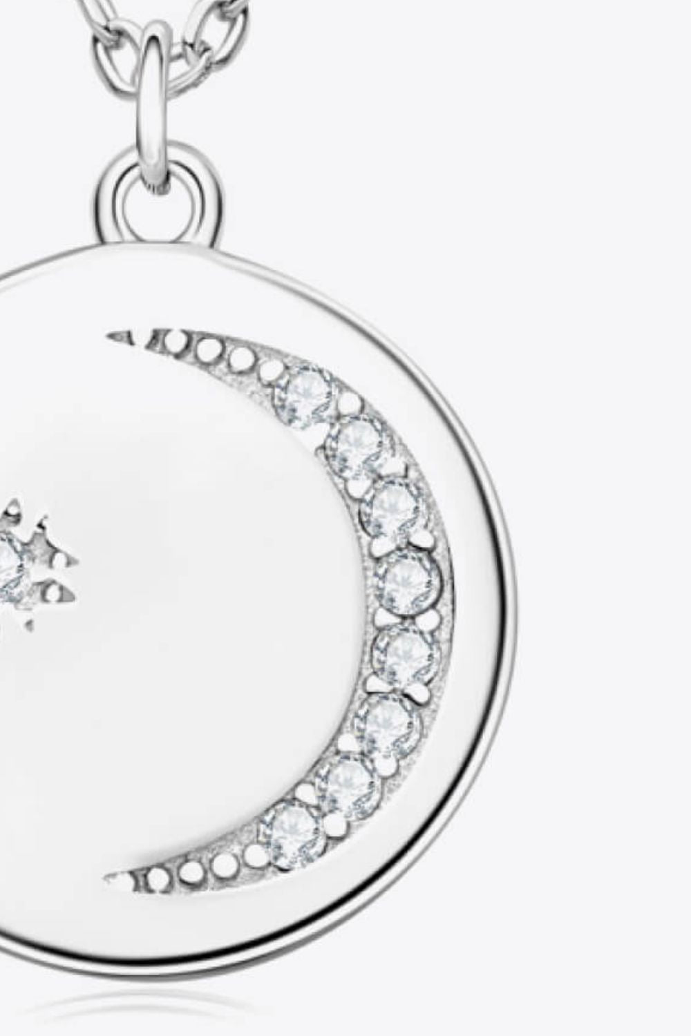 Silver pendant necklace with celestial moon and star design featuring clear crystals