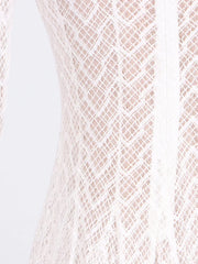 White lace maxi dress with mock neck and long sleeves, showing intricate diamond pattern.