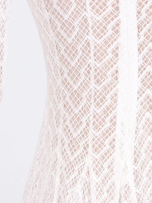 White lace maxi dress with mock neck and long sleeves, showing intricate diamond pattern.