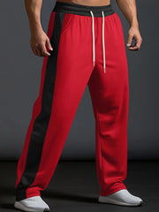 Red track pants with black side panel detail and white drawstring.