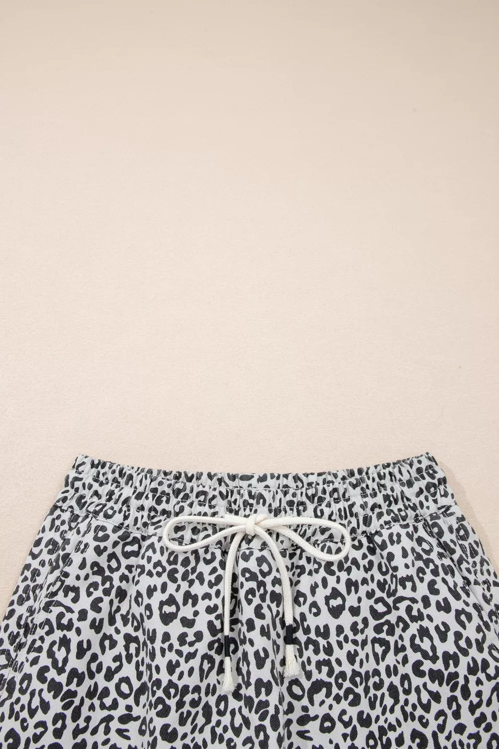 Leopard print denim skort with drawstring waist and pockets.