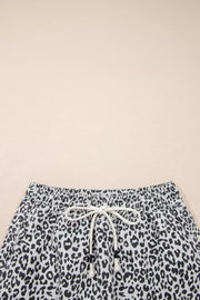 Leopard print denim skort with drawstring waist and pockets.
