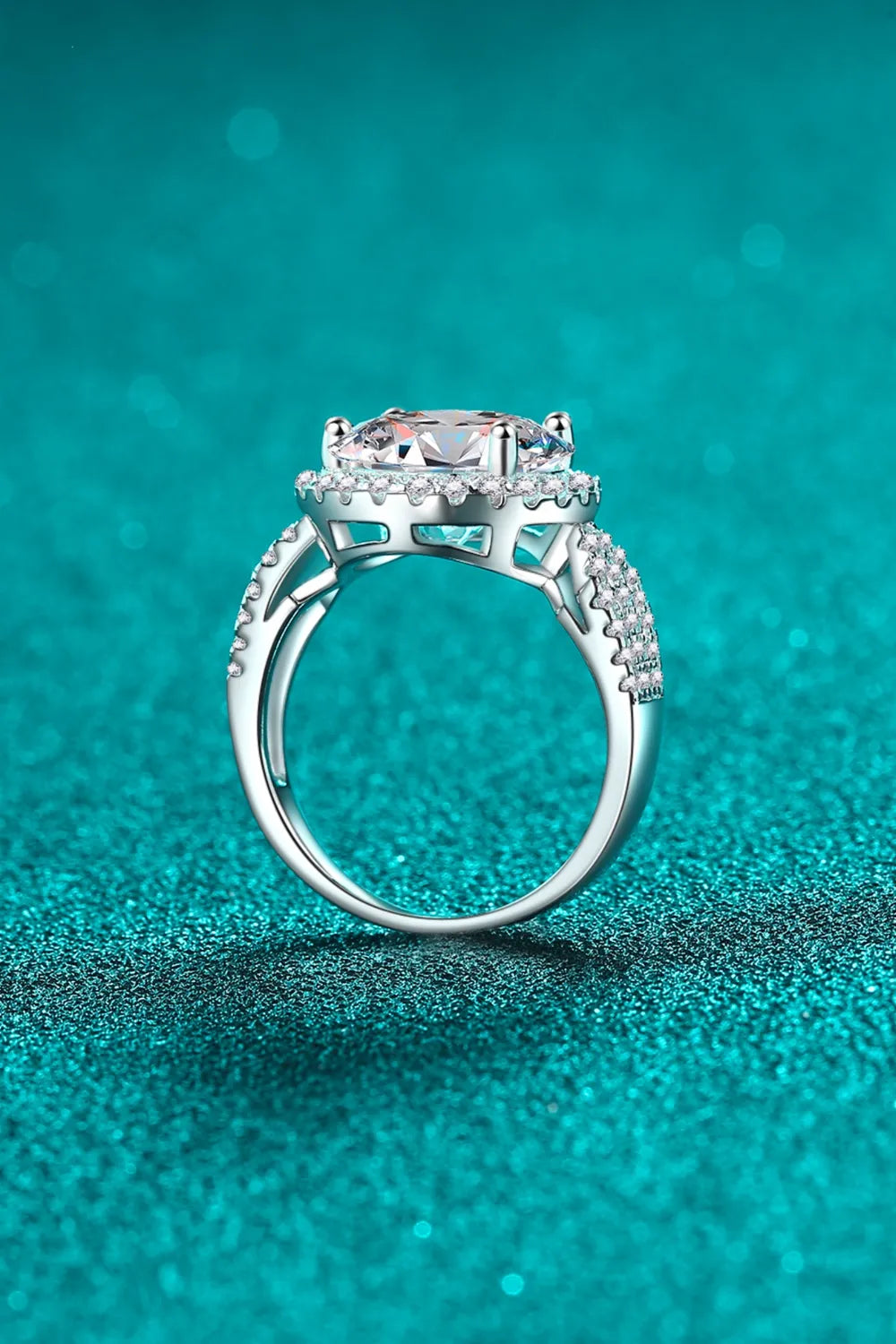 Silver halo moissanite ring with sculpted band and pavé accents