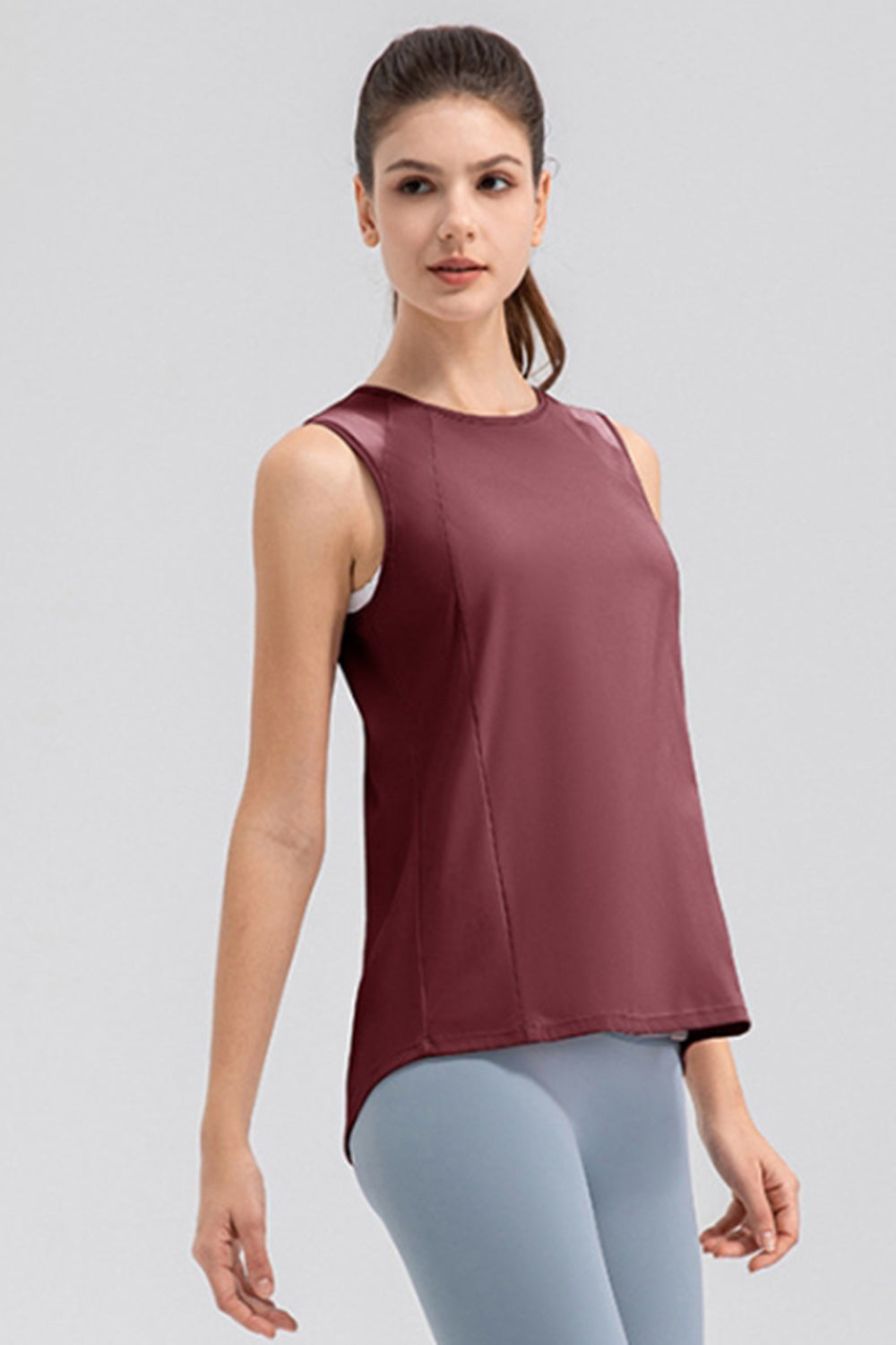 Burgundy activewear tank top with mesh panels and a round neckline.