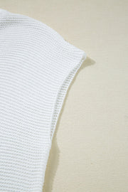 White knit crop top with a textured stitch and open weave detail on the sleeve hem.