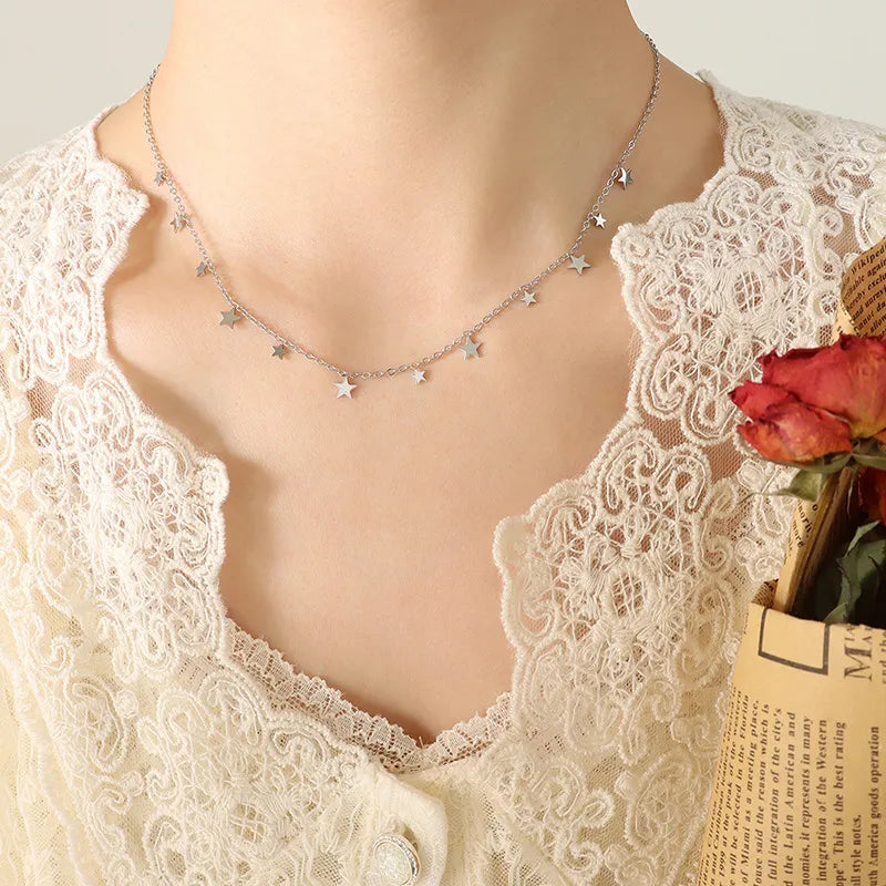 Silver star charm chain necklace with delicate dangling stars.