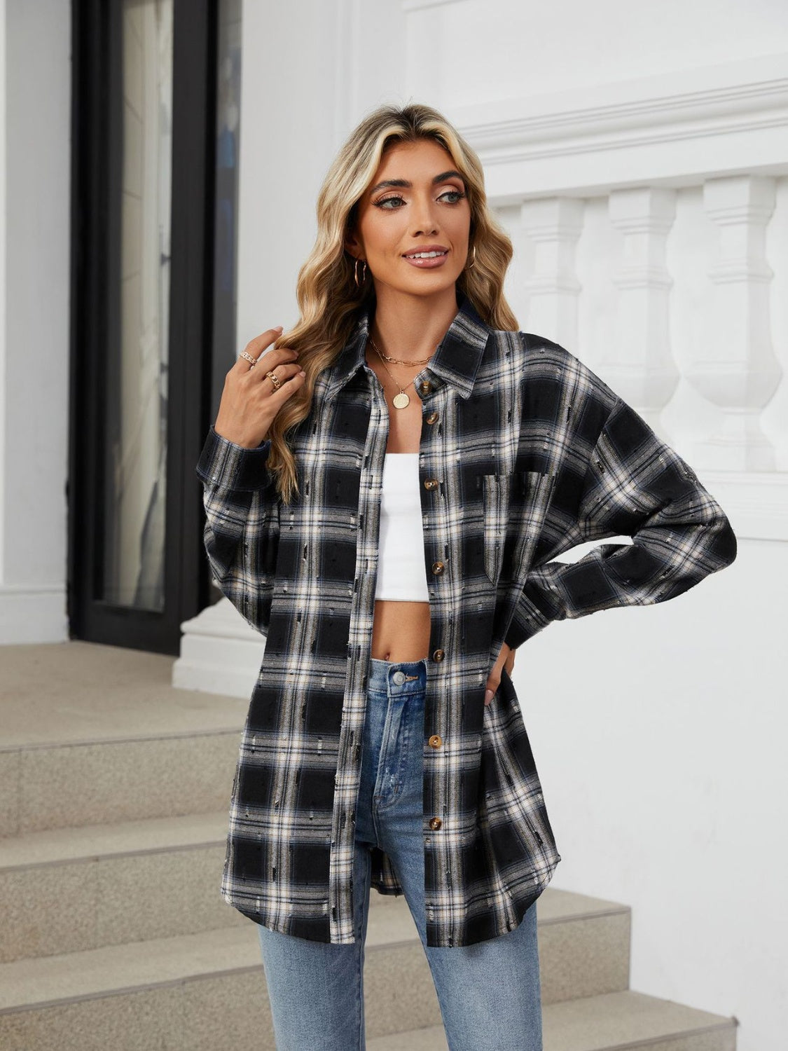 Black plaid relaxed fit overshirt with distressed details and button front.