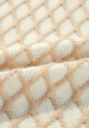 Cream diamond knit sweater with balloon sleeves, close-up detail