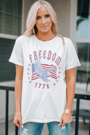 White graphic tee with eagle, American flag, and Freedom 1776 print