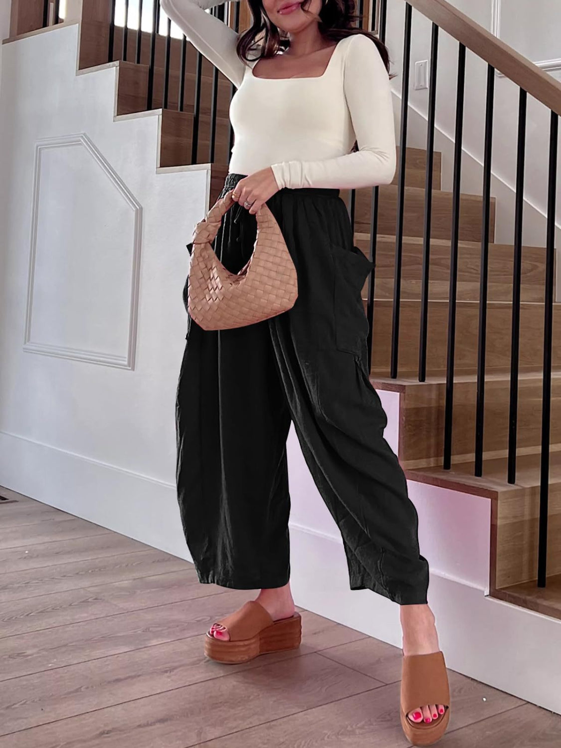 Black linen balloon trousers with cargo pockets and a relaxed fit.