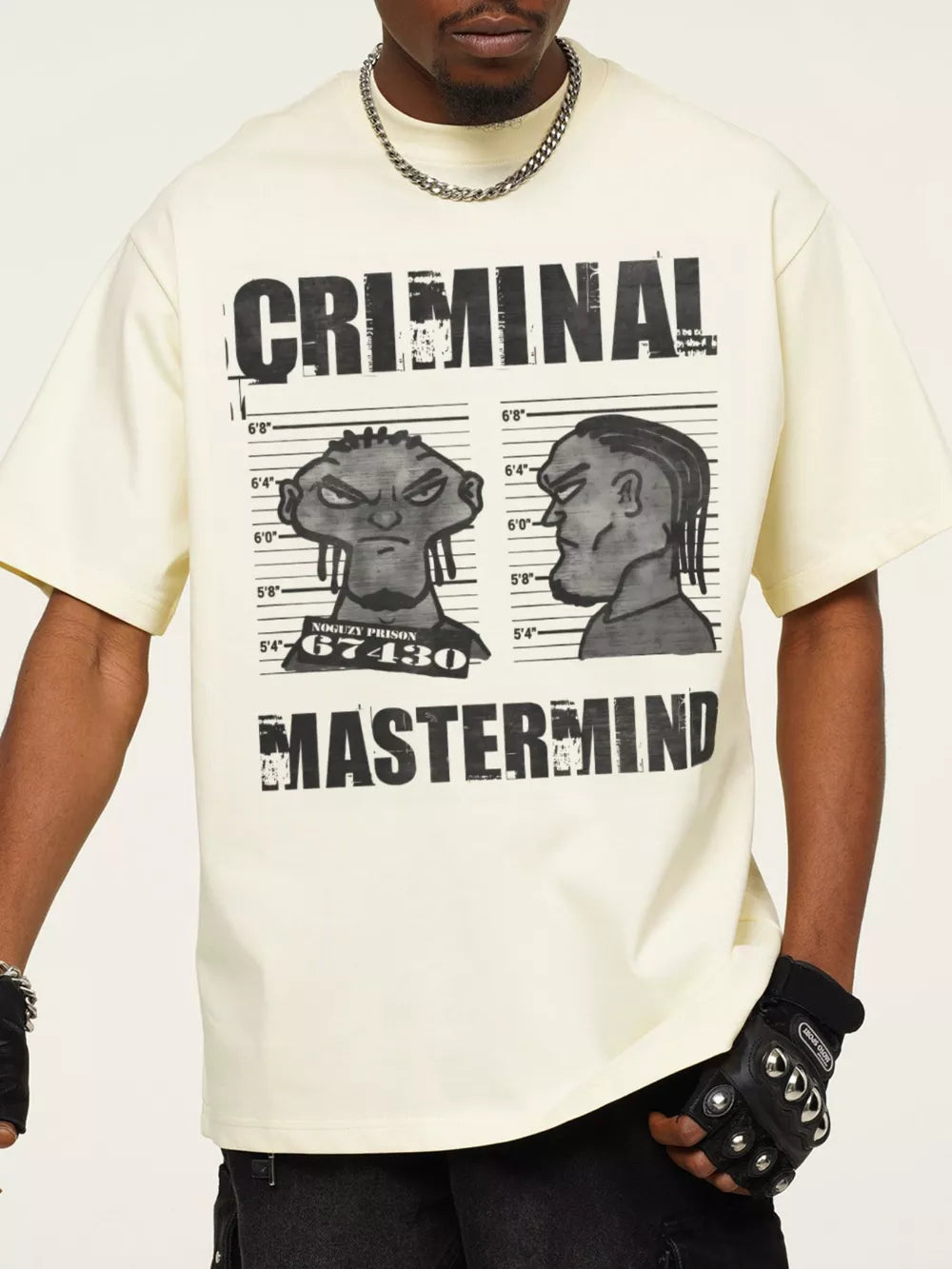 Pastel yellow cotton oversized tee with bold "CRIMINAL MASTERMIND" graphic print and cartoon mugshot.