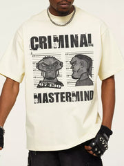 Pastel yellow cotton oversized tee with bold "CRIMINAL MASTERMIND" graphic print and cartoon mugshot.