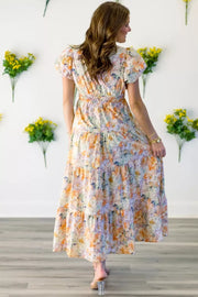 Vibrant floral smocked maxi dress with tiered skirt and short puff sleeves.