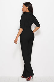 Black belted palazzo jumpsuit with high neckline and 3/4 sleeves.