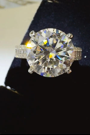 Silver moissanite crown ring with pavé band detail and large round center stone.