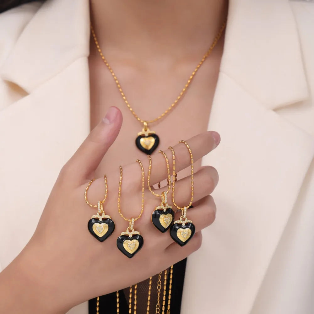 Gold necklace with black enamel heart pendant and Czech diamonds.
