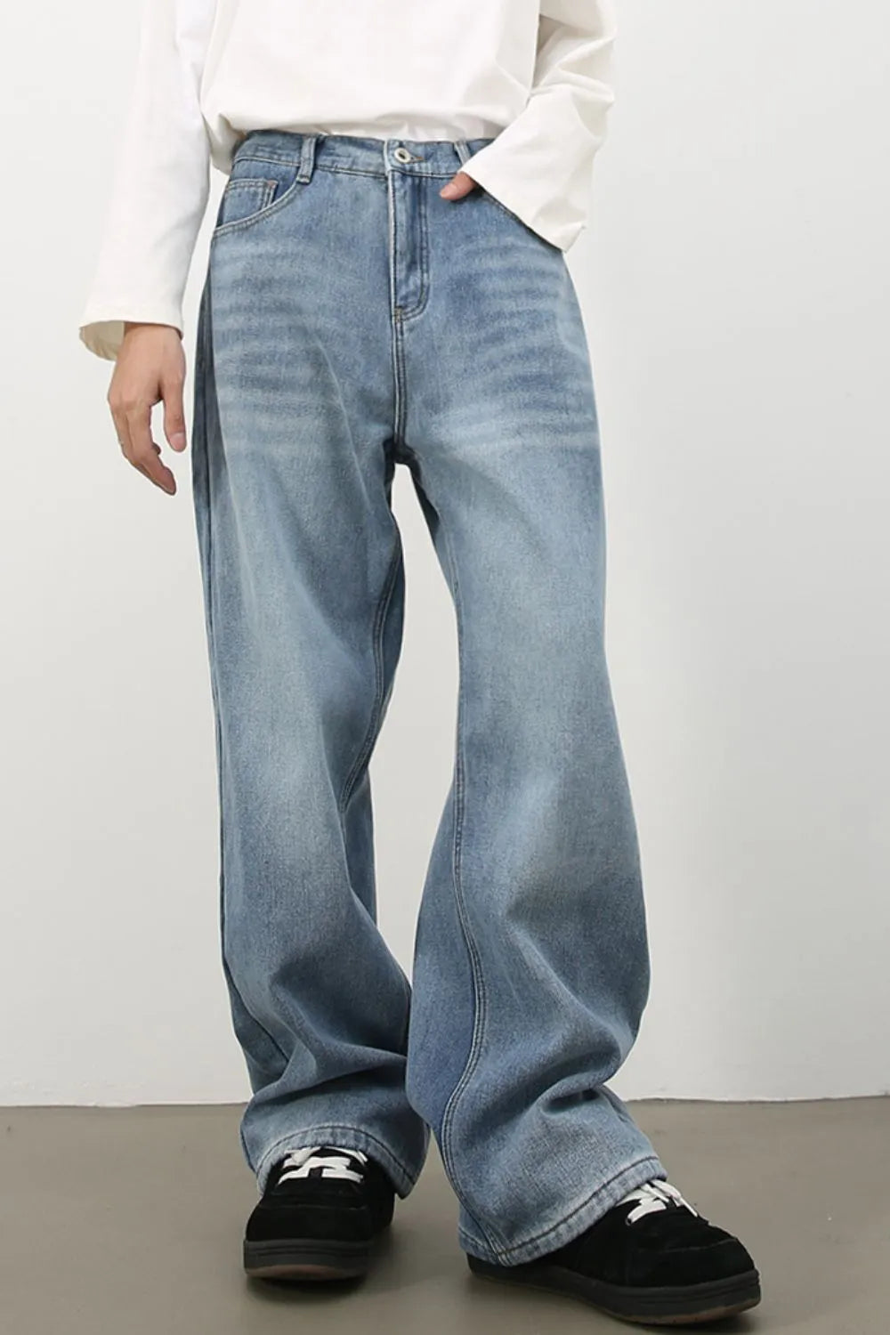 Oversized medium wash denim jeans with a fade effect, wide leg and relaxed fit.