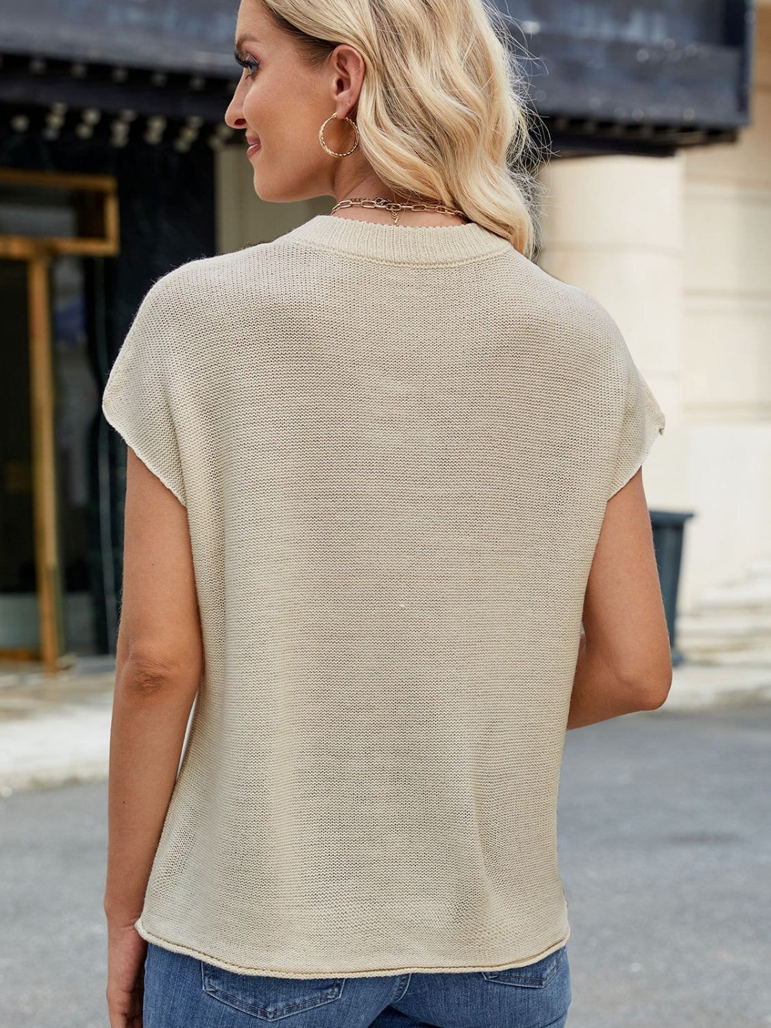 Tan knit cap sleeve top with vertical seam detail.