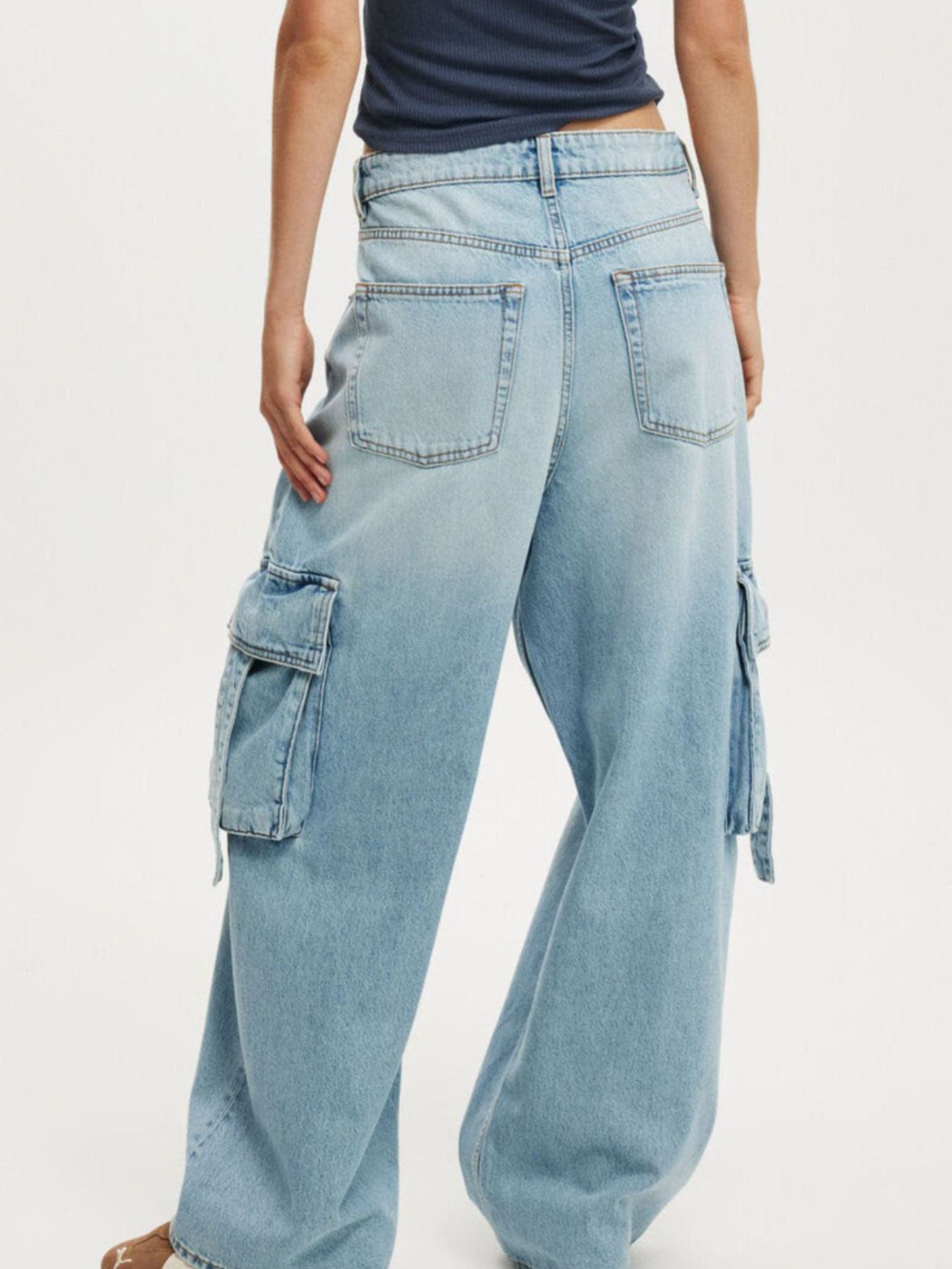 Light blue denim maternity cargo jeans with vintage wash and ankle length.