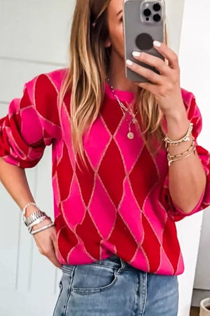 Vibrant argyle knit sweater in deep rose and red with puff sleeves and a crew neck.