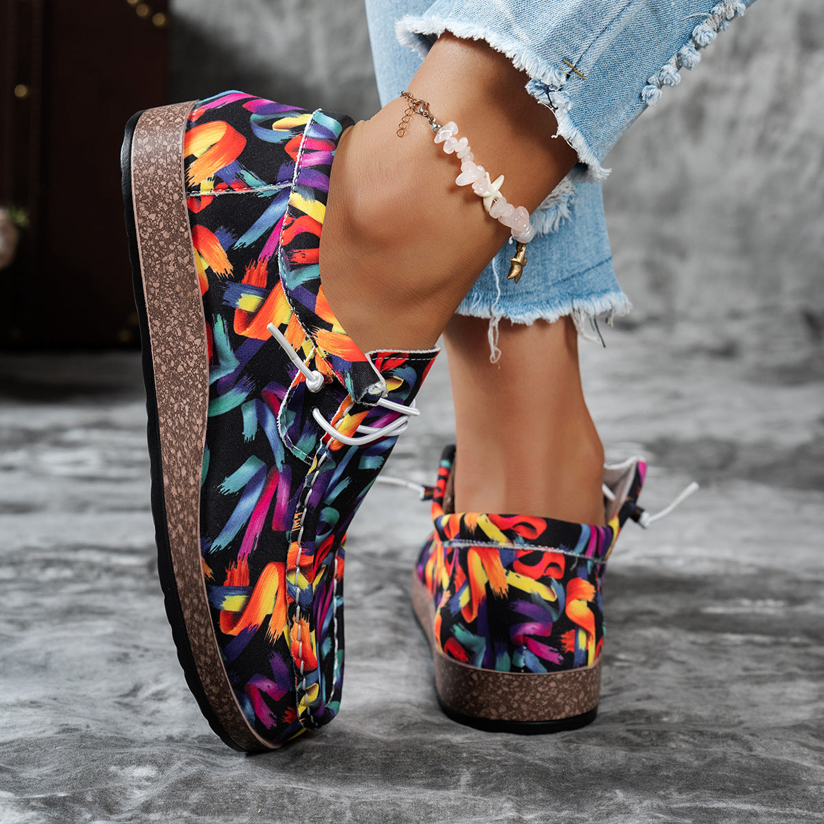 Printed casual slip-on loafers with abstract brushstroke pattern in black and multicolor.