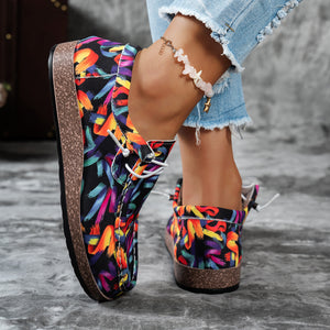 Printed casual slip-on loafers with abstract brushstroke pattern in black and multicolor.