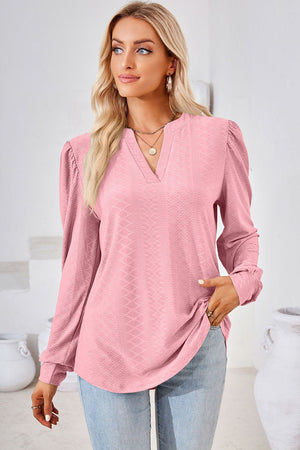 Blush pink textured henley blouse with puff sleeves and V-neck