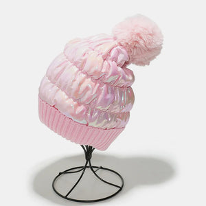 Pink metallic padded beanie with faux fur pom and ribbed knit cuff.
