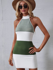Green and white colorblock halter knit mini dress with a bow detail.