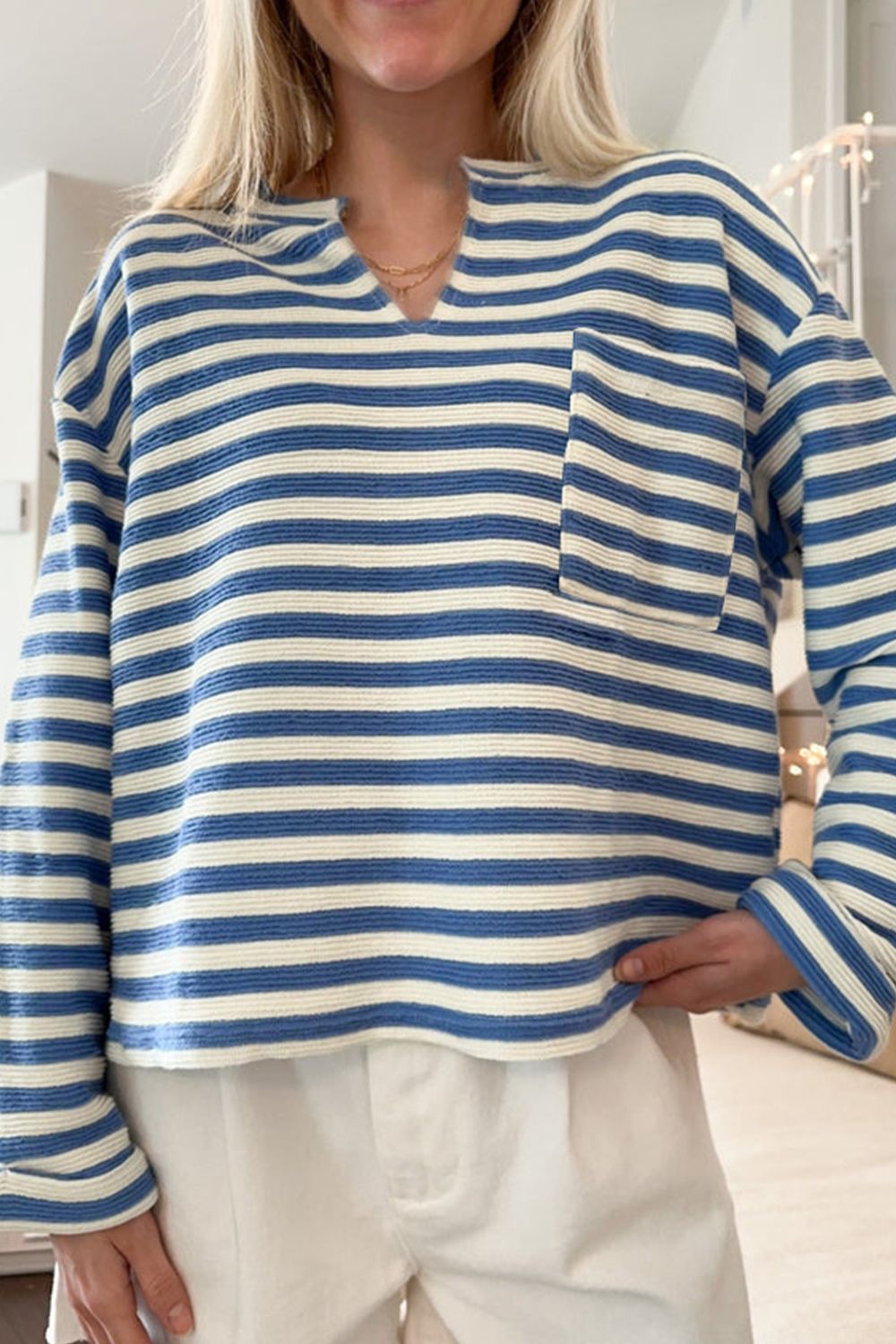 Peacock blue and white striped textured henley top with chest pocket and notch neckline.
