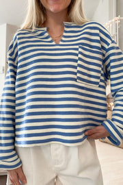 Peacock blue and white striped textured henley top with chest pocket and notch neckline.