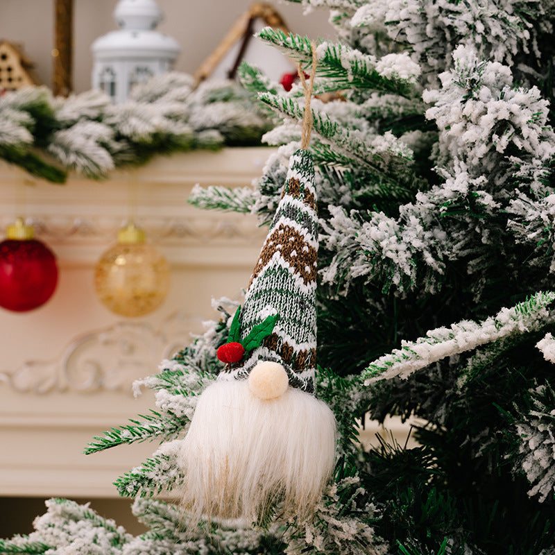 Knitted gnome ornament with white beard and pompom nose, green and brown striped hat.