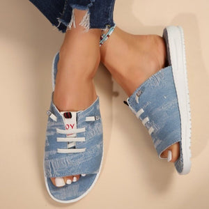 Light blue distressed canvas open-toe platform sandals with white laces and rhinestone accents.