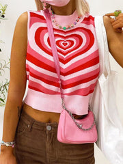 Pink knit tank top with concentric heart intarsia pattern and mock neck.