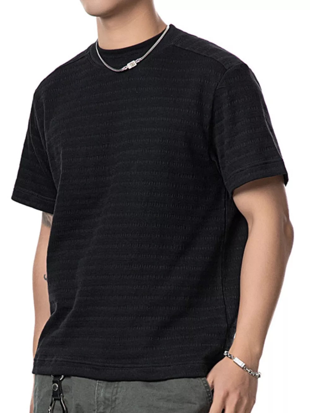 Men's black textured knit crew neck t-shirt with short sleeves.