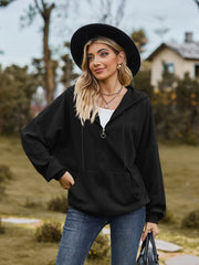 Black textured knit dolman sleeve hoodie with quarter zip and front pocket.