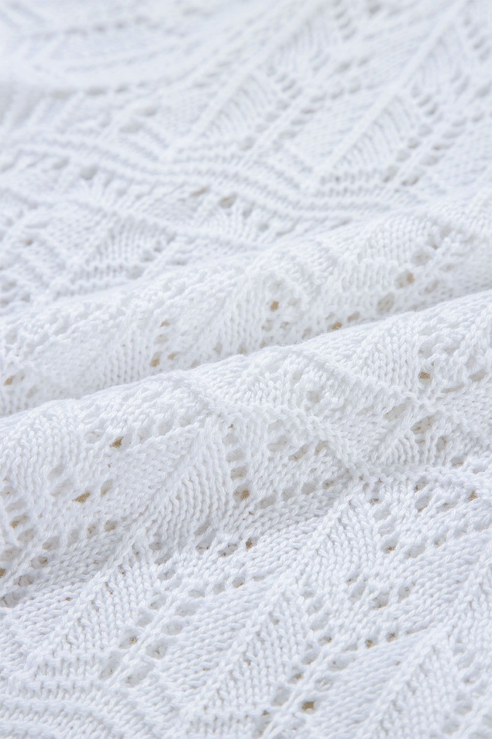 White openwork crochet cardigan with a diamond pattern and breathable acrylic knit.