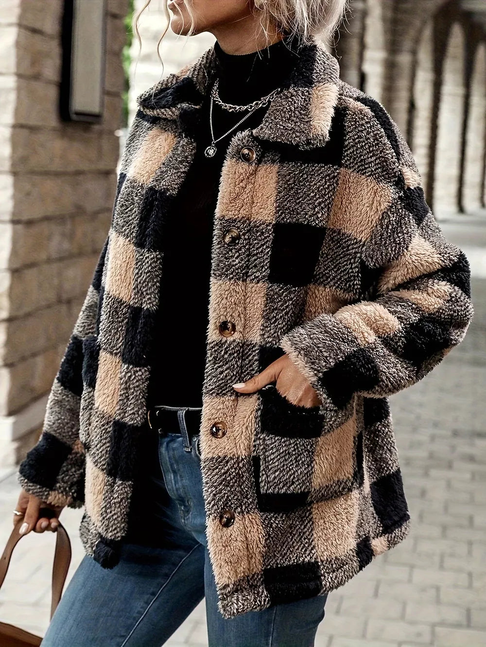 Cozy plaid sherpa trench coat in camel and black check with button front and pockets.