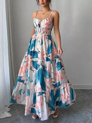 Maxi dress with tropical floral print, tie-front bodice, tiered skirt, and spaghetti straps.