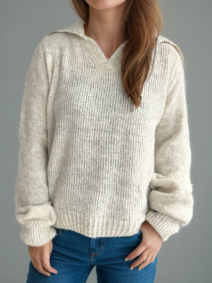 Beige textured knit polo sweater with a relaxed fit and ribbed cuffs and hem.