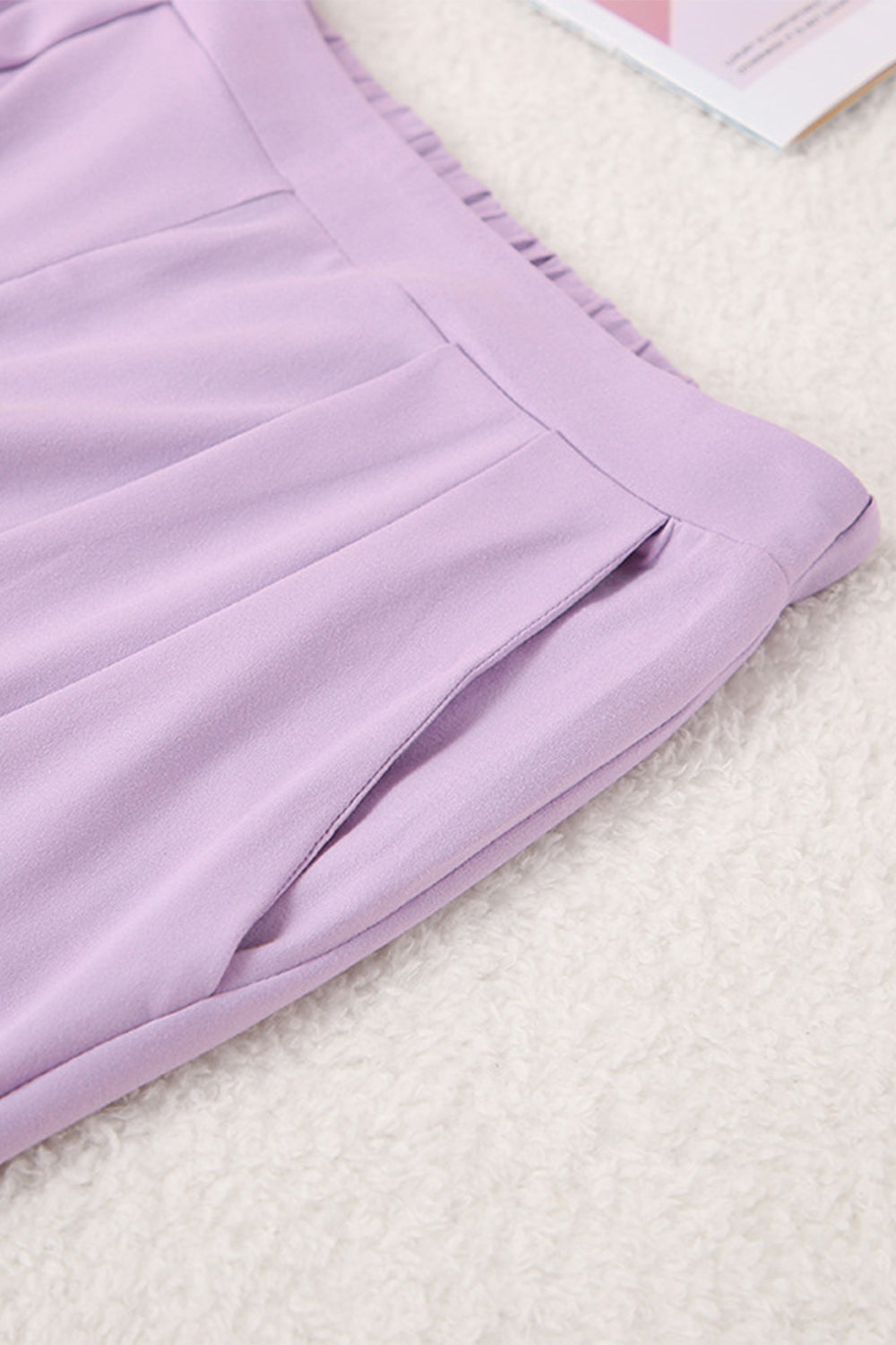 Lavender pleated trousers with a pocket detail and elastic waistband.
