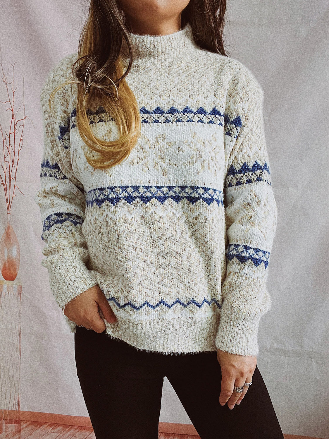 Geometric knit mockneck pullover in cream with blue zigzag pattern, acrylic blend.