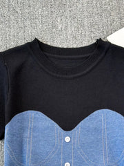 Color block knit t-shirt with ribbed neckline and denim bustier detail in black with blue.