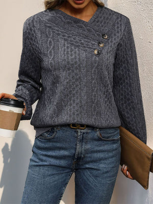 Dark gray cable knit sweater with asymmetric button neck detail and V-neck.