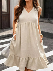 Khaki V-neck sleeveless dress with ruffle hem and textured fabric.