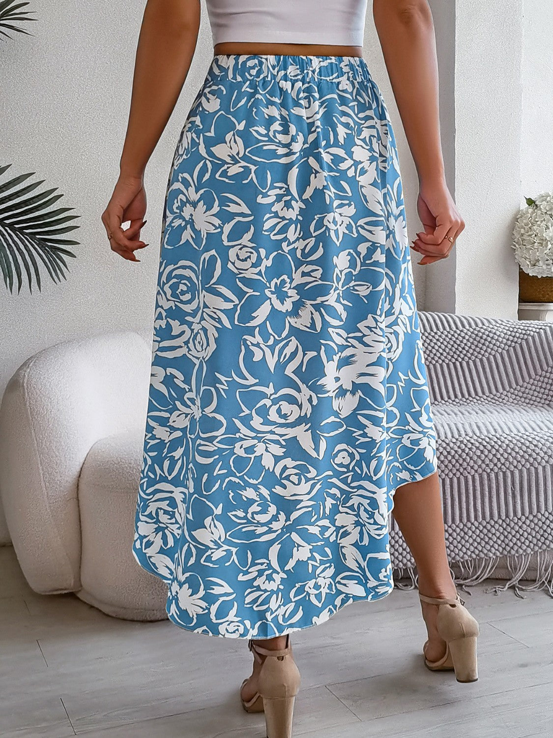Asymmetric midi skirt in pastel blue with a white floral print and a hi-low hem.