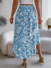 Asymmetric midi skirt in pastel blue with a white floral print and a hi-low hem.