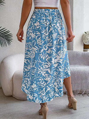 Asymmetric midi skirt in pastel blue with a white floral print and a hi-low hem.