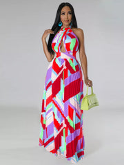 Halter neck maxi dress with geometric print, cut-out, and pleated skirt.